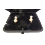 ART DECO PAIR OF CULTURED PEARL EARRINGS, cultured pearls to faceted frames, with hook fittings, 7mm