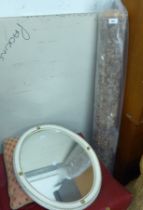 A WHITE FRAMED OVAL WALL MIRROR AND AN OBLONG RUG (2)