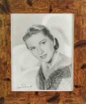 JOAN FONTAINE, SIGNED BLACK AND WHITE PROMOTIONAL PHOTOGRAPH, bust portrait, facing left, 9 ½” x