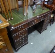 A MAHOGANY DOUBLE PEDESTAL DESK, HAVING 2 BANKS OF FOUR DRAWERS, WITH GREEN INSET TOP