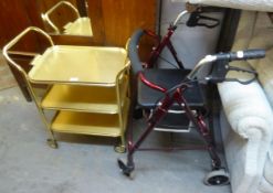 A GILT METAL THREE TIER TEA TROLLEY AND A SIDE-FOLDING WALKING FRAME, WITH BRAKES (2)