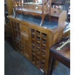 WINE RACK; GRANITE TOP GALLERIED PINE WINE RACK CABINET WITH CENTRAL DRAWER AND CUPBOARD, 51" (