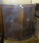 A 1930’S OAK BOW FRONTED CORNER CUPBOARD, WITH TWO DOORS, WITH APPLIED FRET CARVED DECORATION