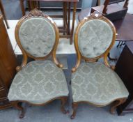 A PAIR OF VICTORIAN LOW-SEATED SINGLE CHAIRS, WITH BUTTON UPHOLSTERED OVAL BACK PANELS AND SEAT IN