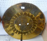 A MIDDLE EASTERN ENGRAVED BRASS CIRCULAR COFFEE TABLE TRAY TOP, WITH CENTRAL WELL, THE CENTRE AND