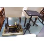 AN OLD SINGER SEWING MACHINE AND A SMALL WROUGHT IRON STAND (2)