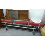 1960's AMBULANCE STRETCHER, OF TUBULAR ALLOY CONSTRUCTION WITH DEEP RED UPHOLSTERED COVER, 76 1/