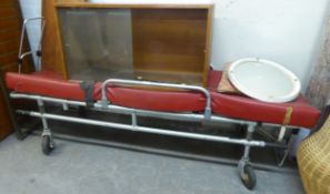 1960's AMBULANCE STRETCHER, OF TUBULAR ALLOY CONSTRUCTION WITH DEEP RED UPHOLSTERED COVER, 76 1/