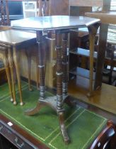 AN OCTAGONAL OAK OCCASIONAL TABLE, ON THREE LEGS AND TRIPOD SUPPORTS