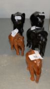 THREE AFRICAN CARVED EBONY MODELS OF ELEPHANTS WITH (MINUS TUSKS) TUSKS AND TWO SOFT WOOD