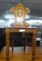 TWENTIETH CENTURY OAK HALL CHAIR, SHIELD SHAPED BACK OVER SOLID SEAT