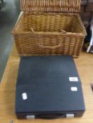 A SILVER REED MANUAL PORTABLE TYPEWRITER AND A WICKER BASKET (2)