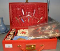 A RED MOROCCO SUITCASE PATTERN FITTED SEWING CASE AND CONTENTS, 12” WIDE