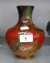 A RED AND GILT FOLIATE DECORATED POTTERY GLOBULAR VASE WITH SHORT NECK, 7” HIGH