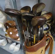VINTAGE GOLF CLUBS, WOODEN AND METAL SHAFTS AND HEADS IN A CLOTH AND LEATHER BAG. TOGETHER WITH