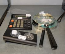 TWO LARGE MAGNIFYING GLASSES; A SMALL DIGITAL DESK CLOCK/THERMOMETER; A CALCULATOR AND DESK