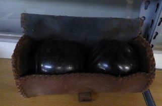 A PAIR OF LIGNUM VITAE LAWN BOWLS, IN CASE