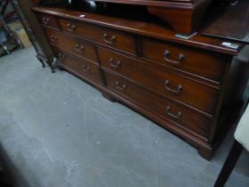 A LONG MAHOGANY REPRODUCTION CHEST OF SEVEN DRAWERS, 71cm high x 47cm deep x 180cm long