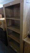 AN 'OAK FURNITURE LAND' OPEN BOOKCASE, HAVING FOUR DRAWERS AND SINGLE DRAWER BELOW, 175cm high x