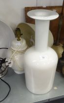 A LARGE, WHITE OPAQUE GLASS BOTTLE VASE AND A SIMILAR TABLE LAMP AND SHADE