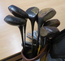 VINTAGE GOLF CLUBS, WOODEN AND METAL SHAFTS AND HEADS IN A CLOTH AND LEATHER BAG.  TOGETHER WITH TWO