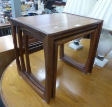 A NEST OF THREE G-PLAN TEAK OBLONG COFFEE TABLES, ON CONTINUOUS SUPPORTS