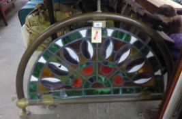 A STAINED GLASS BAR PANEL, SET INTO BRASS FRAMEWORK (DAMAGE TO THE STAINED GLASS)