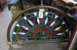 A STAINED GLASS BAR PANEL, SET INTO BRASS FRAMEWORK (DAMAGE TO THE STAINED GLASS)