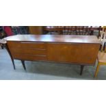 A SCANDINAVIAN TEAK LONG LOW SIDEBOARD, HAVING A DOUBLE SLIDING DOOR AND THREE LONG DRAWERS