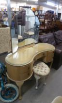 A KIDNEY SHAPED LIMED OAK DRESSING TABLE, HAVING TRIPLE MIRRORS AND A SIMILAR DRESSING TABLE