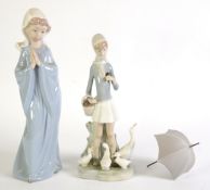 LLADRO PORCELAIN FIGURE OF A GIRL carrying an open umbrella with a family of geese at her feet 9 1/