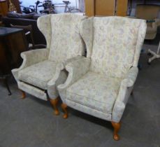 A PAIR OF WINGED FIRESIDE ARMCHAIRS, RECLINING AND WITH EXTENDING LEG RESTS