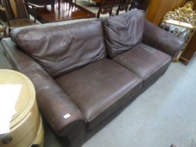 A DARK BROWN HIDE, LOW-BACKED THREE SEATER SETTEE (A.F.)
