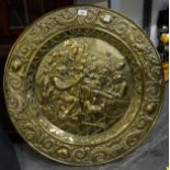 A LARGE CIRCULAR EMBOSSED BRASS PLAQUE