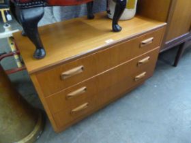 A TEAK LOW CHEST OF THREE LONG DRAWERS, ON PLINTH BASE