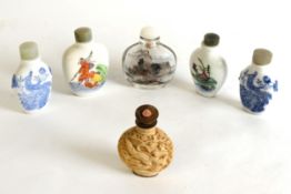 THREE ORIENTAL BLUE AND WHITE PORCELAIN SNUFF BOTTLES; ANOTHER, polychrome decorated; an inside-