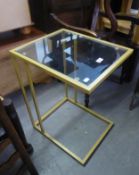 A GILT METAL CANTILEVER OCCASIONAL TABLE, WITH GLASS TOP