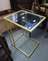 A GILT METAL CANTILEVER OCCASIONAL TABLE, WITH GLASS TOP