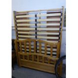 A STYLISH LIGHT OAK DOUBLE BED, HAVING SLATTED HEAD AND FOOT BOARDS AND SIX DRAWERS TO BASE