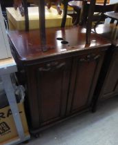 AN ANTIQUE MAHOGANY CARVED TWO DOOR CUPBOARD (HAS BEEN ADAPTED)
