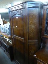 A CARVED OAK HALLROBE WITH BROAD CANTED FORECORNERS