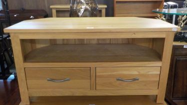 A JOHN LEWIS LIGHT OAK TV STAND WITH TWO DRAWERS, BELOW AN OPEN SECTION