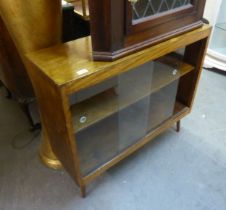 A SMALL LOW STAINED WOOD BOOKCASE, TWO SLIDING GLASS DOORS