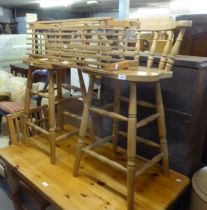 A PAIR OF TALL HARDWOOD WINDSOR STYLE KITCHEN TALL BAR CHAIRS AND A SLATTED WOOD LOW SHOE-RACK (3)