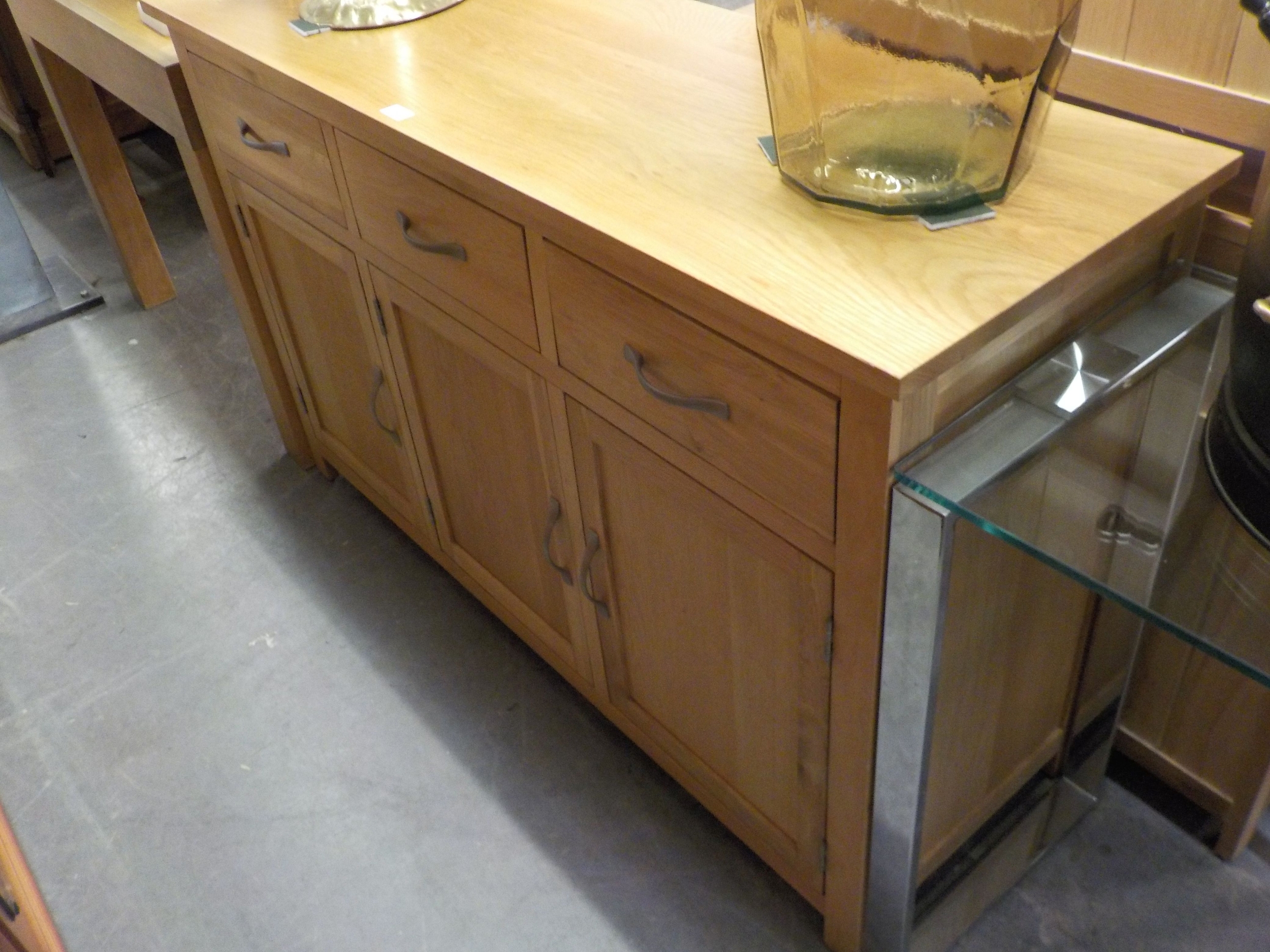 A JOHN LEWIS LIGHT OAK SIDEBOARD, HAVING THREE DRAWERS OVER THREE CUPBOARDS, 86cm HIGH X 45cm DEEP X