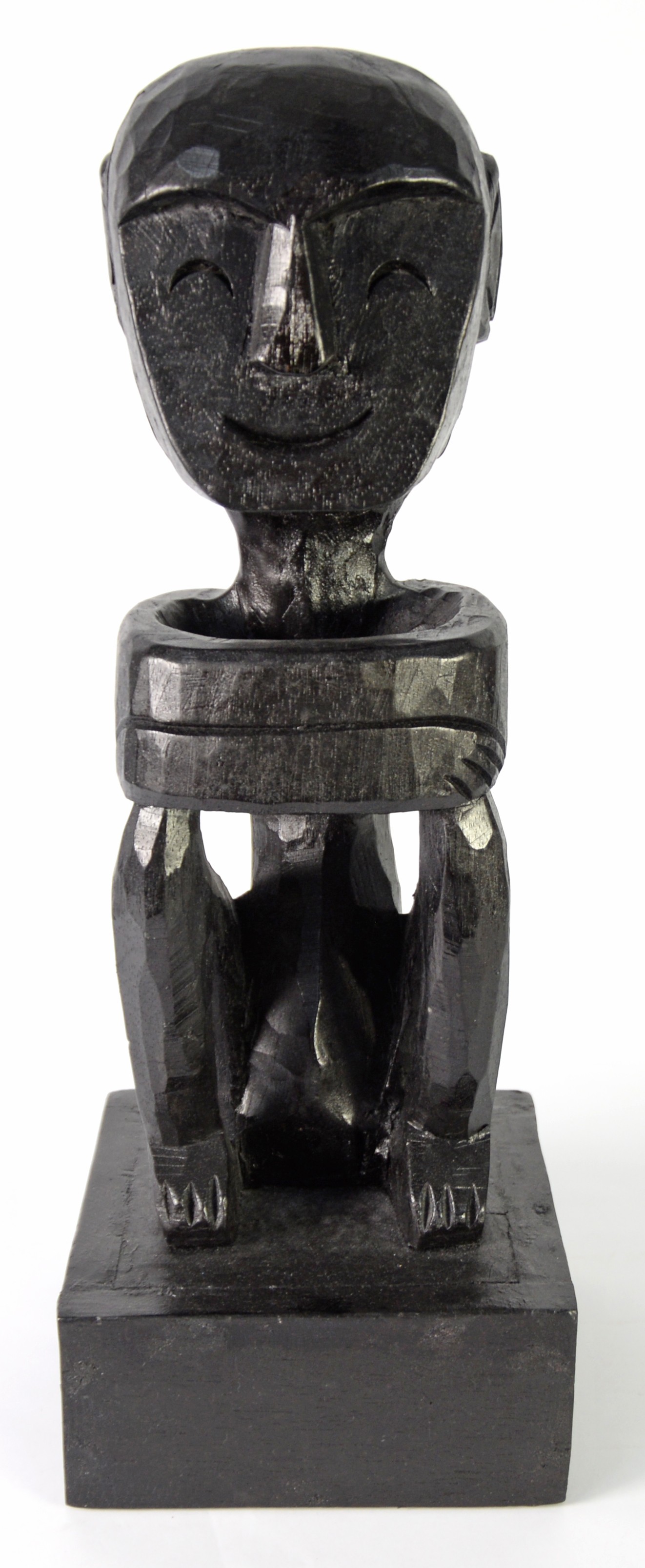 AFRICAN BLACK CARVED SOFTWOOD SEATED MALE FIGURE, 16 1/4in (41.2cm), on square plinth base, 19 1/2in