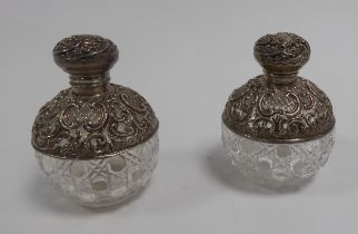 EDWARD VII PAIR OF SILVER MOUNTED CUT GLASS SCENT BOTTLES, each of orbicular form with hinged