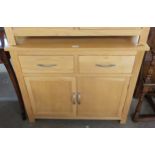 A JOHN LEWIS LIGHT OAK SMALL SIDEBOARD, HAVING TWO DRAWERS OVER TWO CUPBOARDS, 80cm HIGH X 45cm DEEP