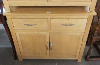 A JOHN LEWIS LIGHT OAK SMALL SIDEBOARD, HAVING TWO DRAWERS OVER TWO CUPBOARDS, 80cm HIGH X 45cm DEEP