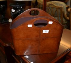 A BROWN LEATHER MAGAZINE RACK